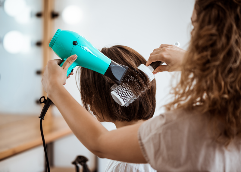 female-hairdresser-making-hairstyle-brunette-woman-beauty-salon